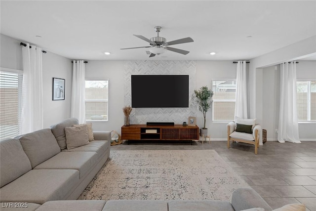 living room featuring plenty of natural light, recessed lighting, baseboards, and a ceiling fan