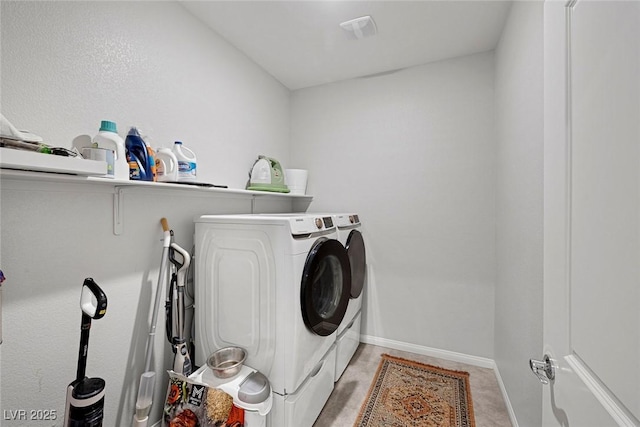 laundry area featuring baseboards, independent washer and dryer, and laundry area