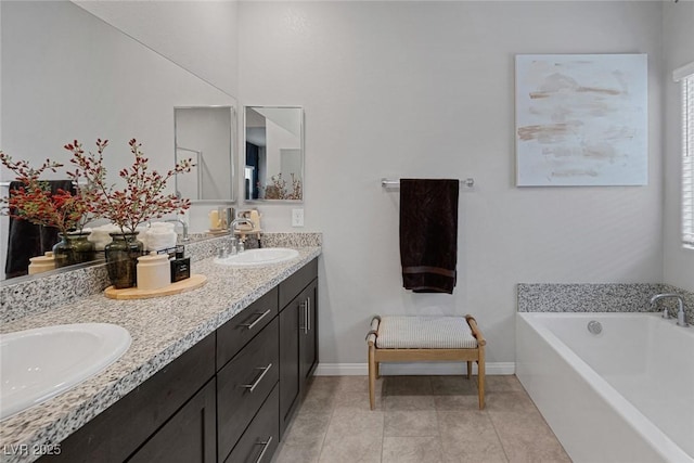 bathroom featuring baseboards, double vanity, a sink, a garden tub, and tile patterned floors