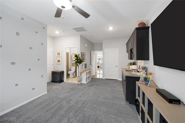 carpeted living area with visible vents, recessed lighting, baseboards, and a ceiling fan