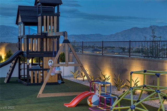 view of play area featuring fence and a mountain view