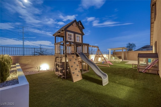 view of playground featuring a lawn and a fenced backyard