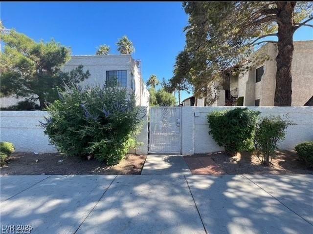 view of gate featuring a patio and fence