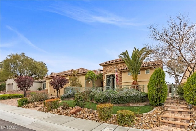 mediterranean / spanish home featuring stucco siding and a tile roof