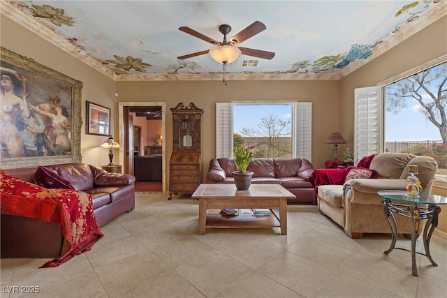 living room with light tile patterned flooring, a ceiling fan, and visible vents