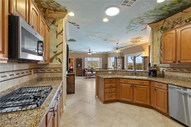 kitchen with visible vents, backsplash, open floor plan, stainless steel appliances, and a peninsula