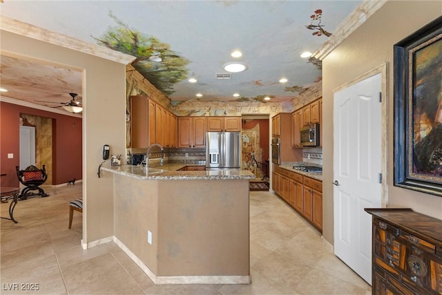 kitchen with visible vents, a ceiling fan, light stone counters, appliances with stainless steel finishes, and a peninsula