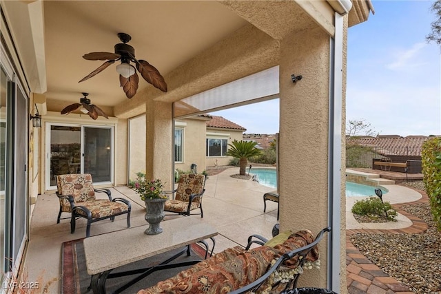 view of patio / terrace with a fenced in pool and ceiling fan