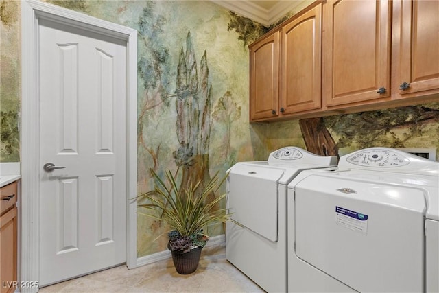 laundry area with wallpapered walls, crown molding, light tile patterned flooring, cabinet space, and independent washer and dryer