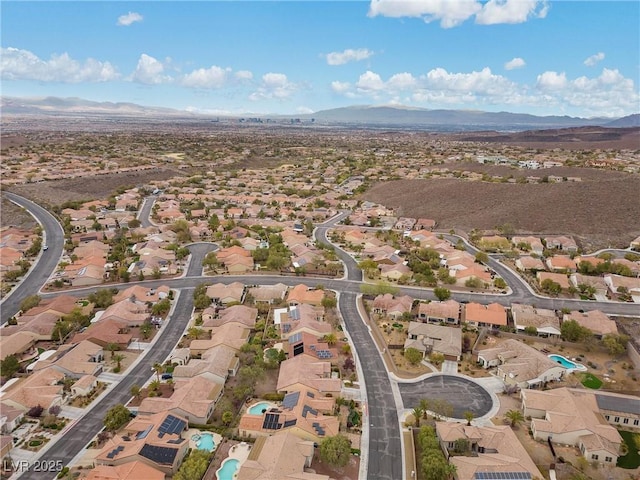 drone / aerial view featuring a residential view and a mountain view