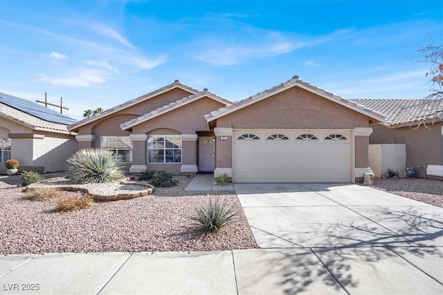 ranch-style house featuring a tiled roof, stucco siding, driveway, and an attached garage