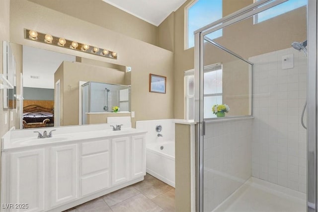 ensuite bathroom featuring a stall shower, a sink, a garden tub, tile patterned floors, and connected bathroom