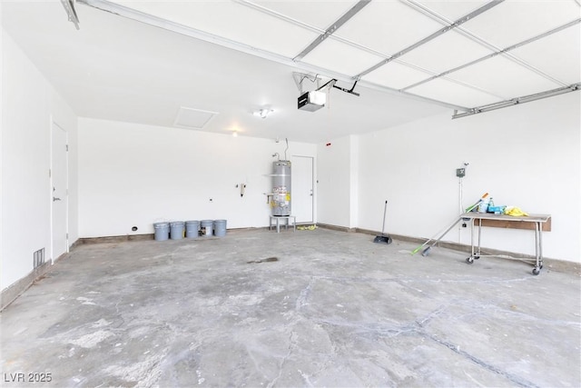 garage with water heater, visible vents, a garage door opener, and baseboards