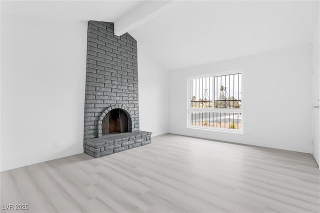 unfurnished living room with wood finished floors, lofted ceiling with beams, and a fireplace