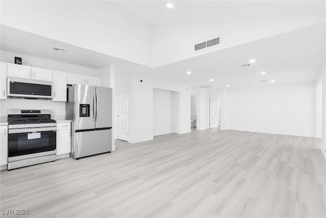 kitchen with light countertops, white cabinets, visible vents, and stainless steel appliances