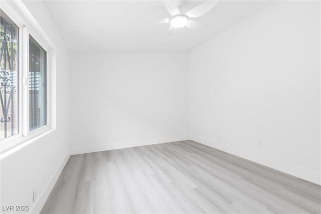 unfurnished room with light wood-style flooring, baseboards, and ceiling fan