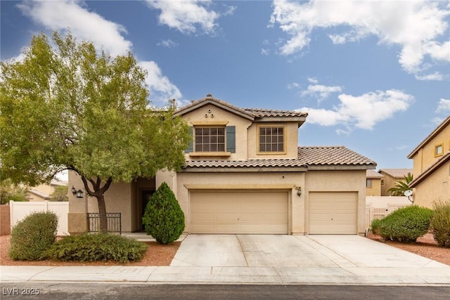 mediterranean / spanish-style house featuring stucco siding, fence, concrete driveway, and a tile roof