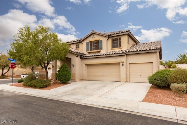 mediterranean / spanish-style home with a tiled roof, stucco siding, driveway, and a garage