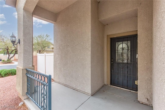 doorway to property featuring stucco siding