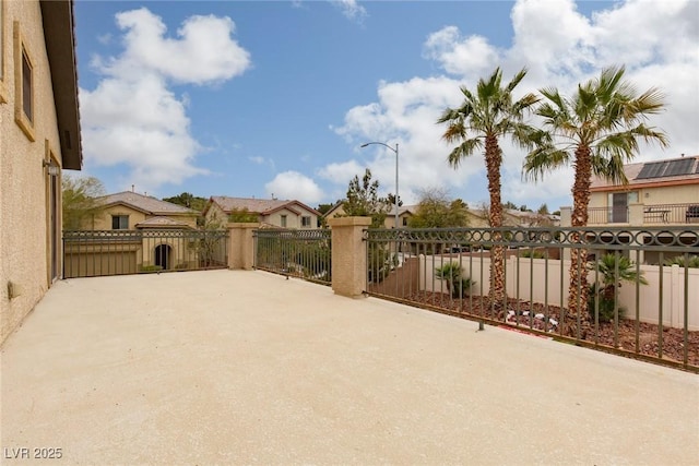 view of gate with a patio and fence