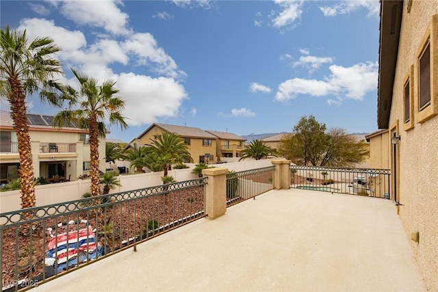 view of patio / terrace with a residential view and fence