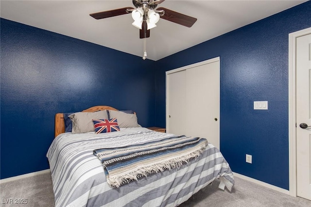 bedroom featuring a closet, ceiling fan, baseboards, and carpet floors