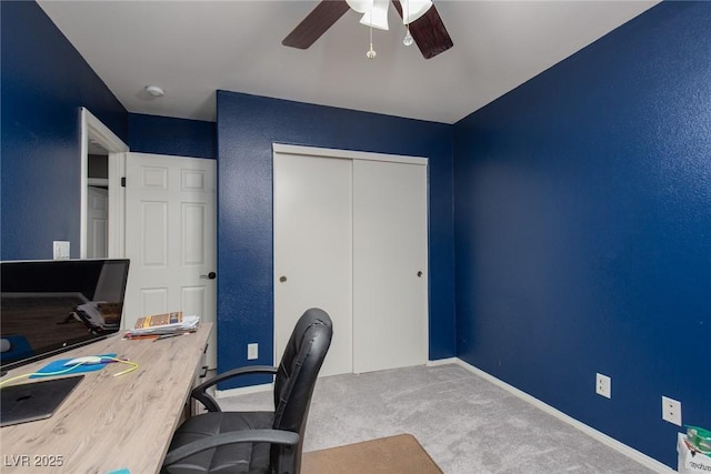 carpeted office with baseboards and ceiling fan