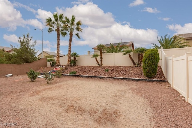 view of yard with a fenced backyard