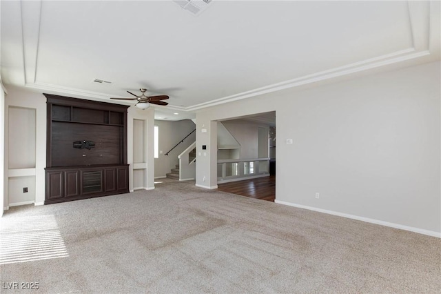 unfurnished living room featuring visible vents, carpet floors, baseboards, and ceiling fan