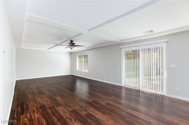 spare room featuring visible vents, plenty of natural light, dark wood-style floors, and a ceiling fan