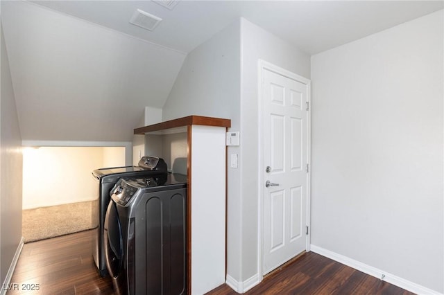 laundry room featuring visible vents, baseboards, dark wood finished floors, laundry area, and washer and dryer