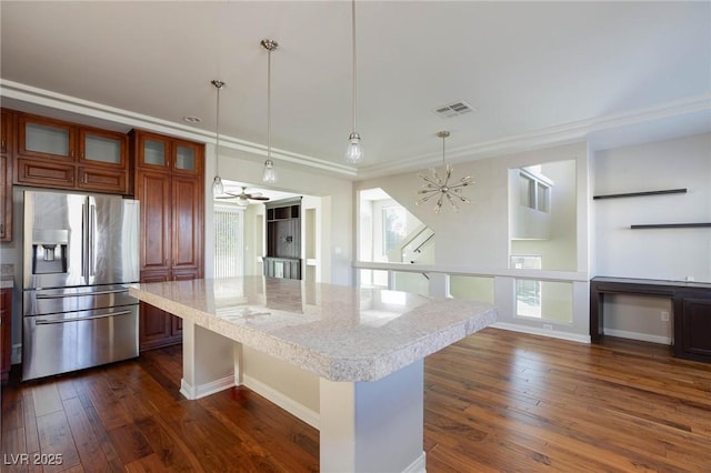 kitchen with dark wood-style floors, visible vents, a healthy amount of sunlight, and stainless steel refrigerator with ice dispenser