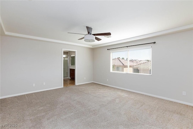 carpeted empty room featuring baseboards and ceiling fan