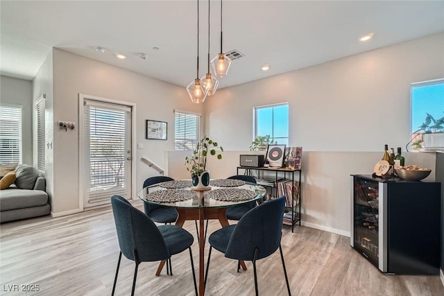 dining space featuring a wealth of natural light, light wood-type flooring, and recessed lighting