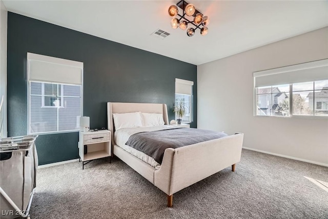 carpeted bedroom featuring visible vents and baseboards