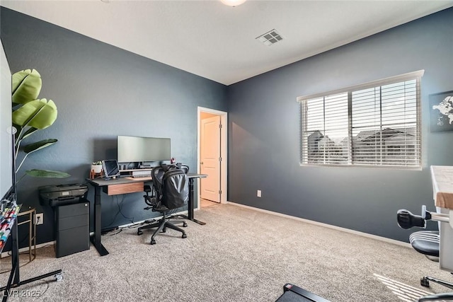 carpeted office with baseboards and visible vents