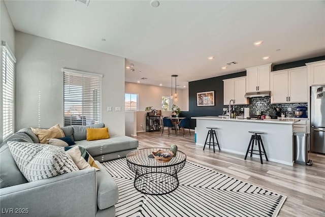 living room featuring recessed lighting and light wood-style floors