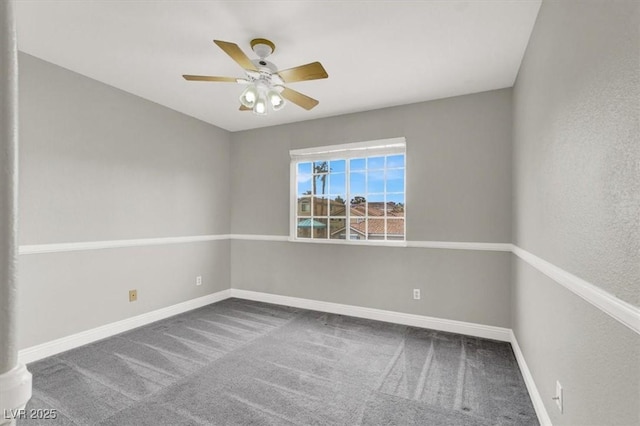 empty room featuring carpet flooring, a ceiling fan, and baseboards