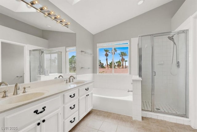 full bathroom featuring vaulted ceiling, a garden tub, a shower stall, and a sink