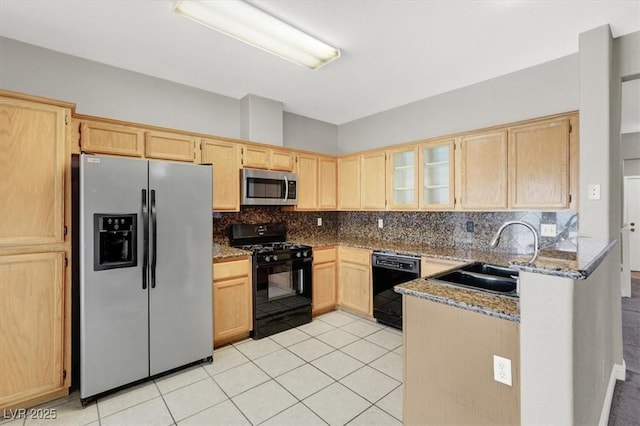 kitchen featuring light tile patterned floors, light brown cabinets, a sink, black appliances, and backsplash