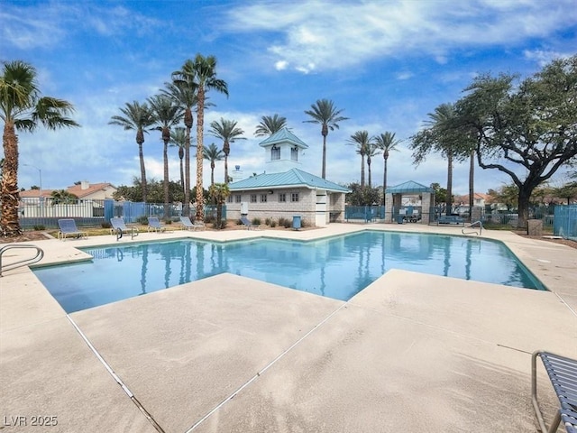 pool with a gazebo, a patio, and fence