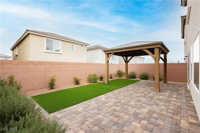 view of patio with a gazebo and a fenced backyard