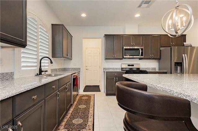 kitchen with visible vents, a sink, recessed lighting, appliances with stainless steel finishes, and dark brown cabinets