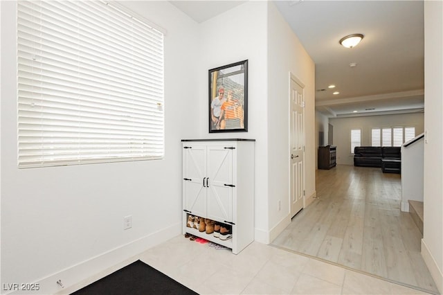 hall featuring recessed lighting, baseboards, and tile patterned floors