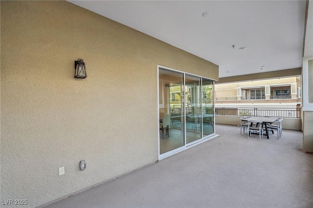 view of patio featuring a balcony