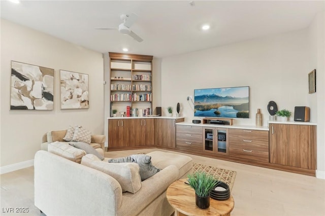 living area featuring recessed lighting, baseboards, and a ceiling fan