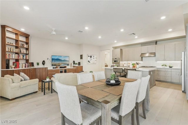 dining space with recessed lighting, visible vents, a ceiling fan, and light wood finished floors