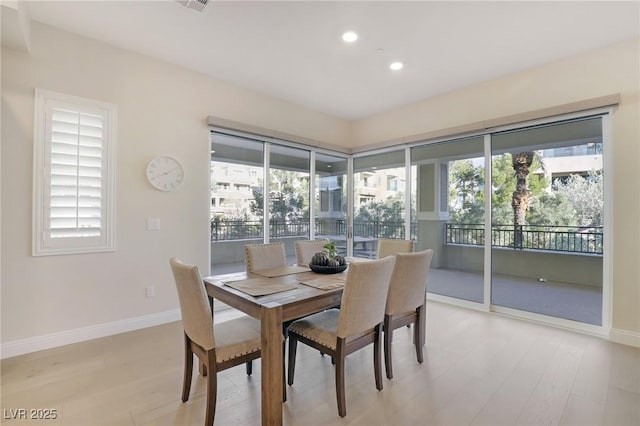 dining area with recessed lighting, baseboards, and light wood finished floors