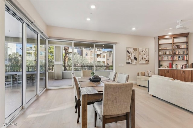 dining room with recessed lighting and light wood-style flooring