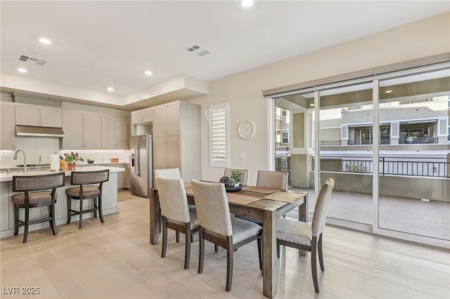 dining room with recessed lighting, visible vents, and light wood finished floors